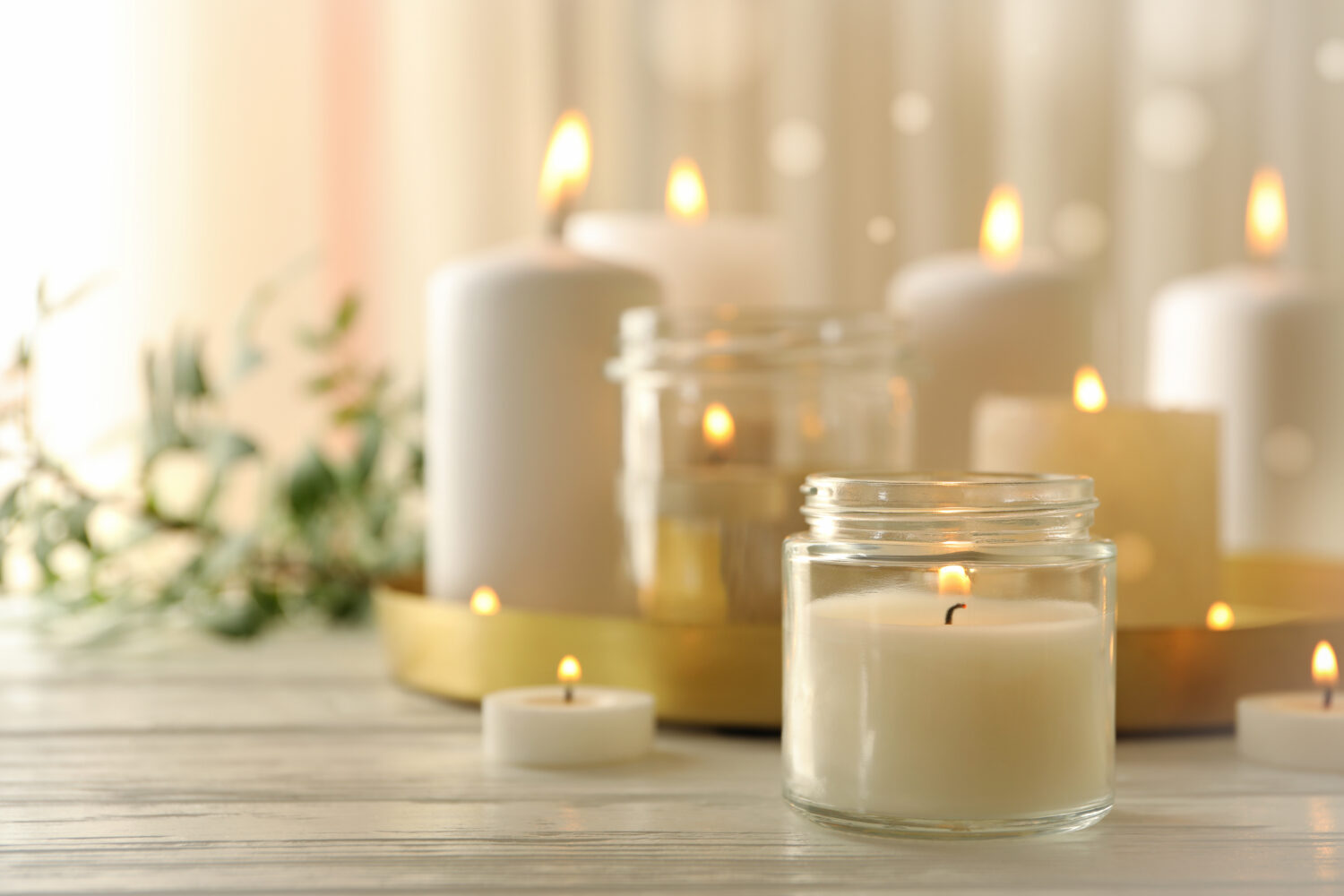 Burning scented candles for relax on white wooden table